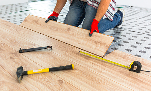 Handyman Installing New Wooden Floor